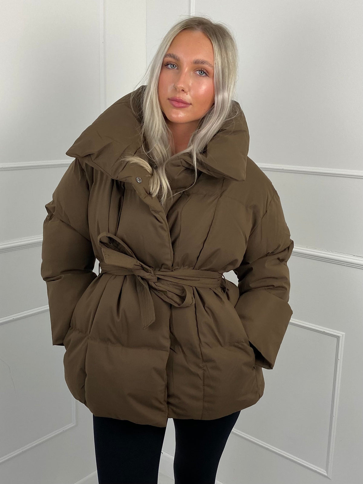 Women's belted puffer jacket, side view