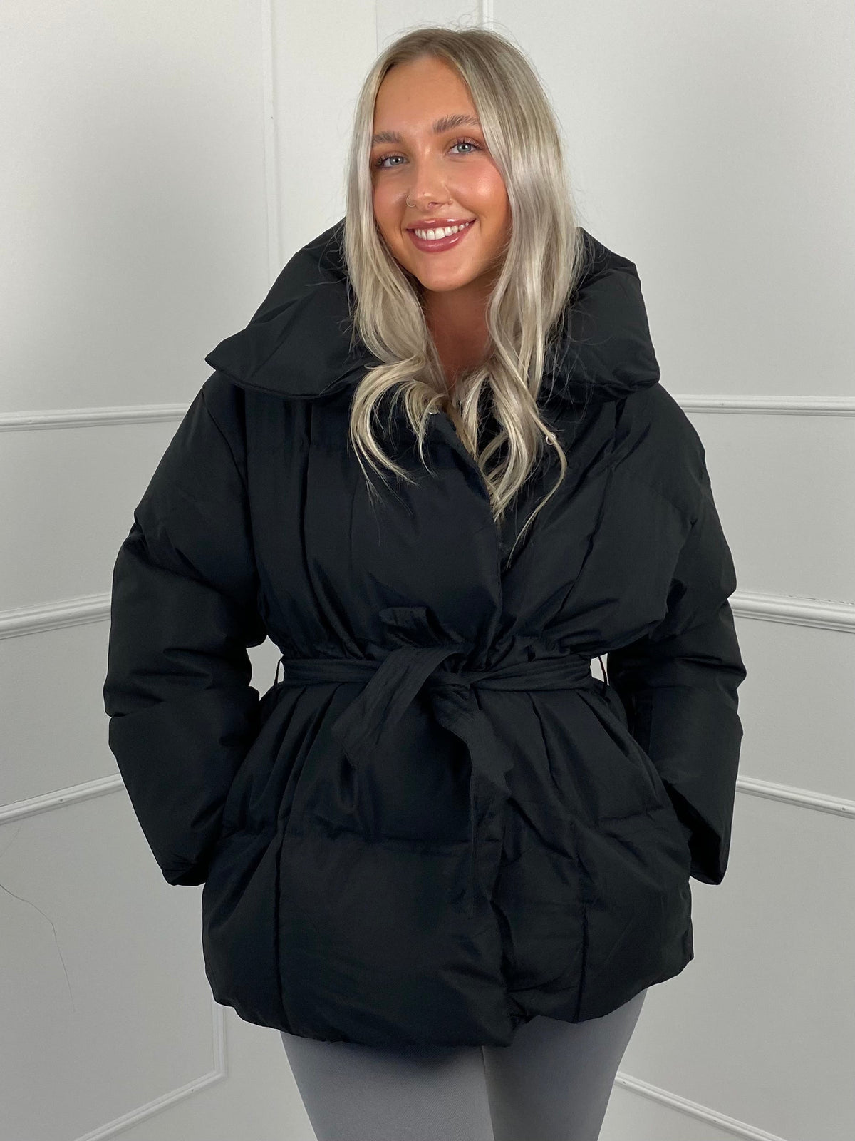Women's belted puffer jacket, back view
