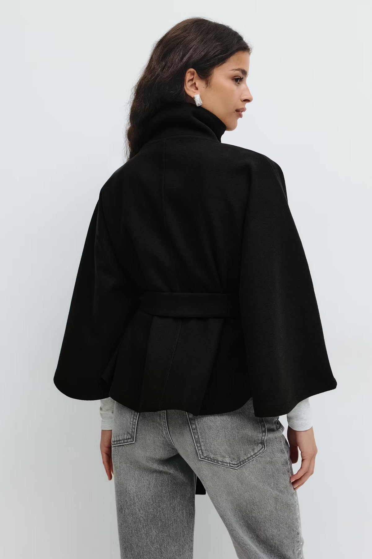 Women's funnel neck cape sleeve draped coat in black, back view