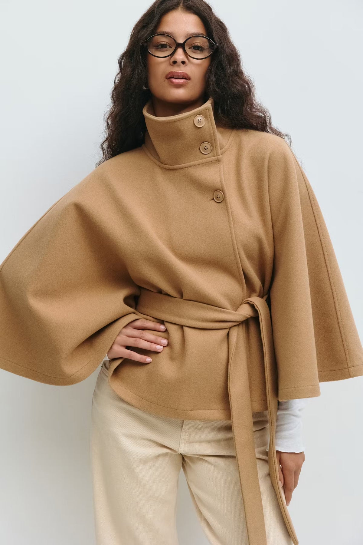 Women's funnel neck cape sleeve draped coat in brown, front view