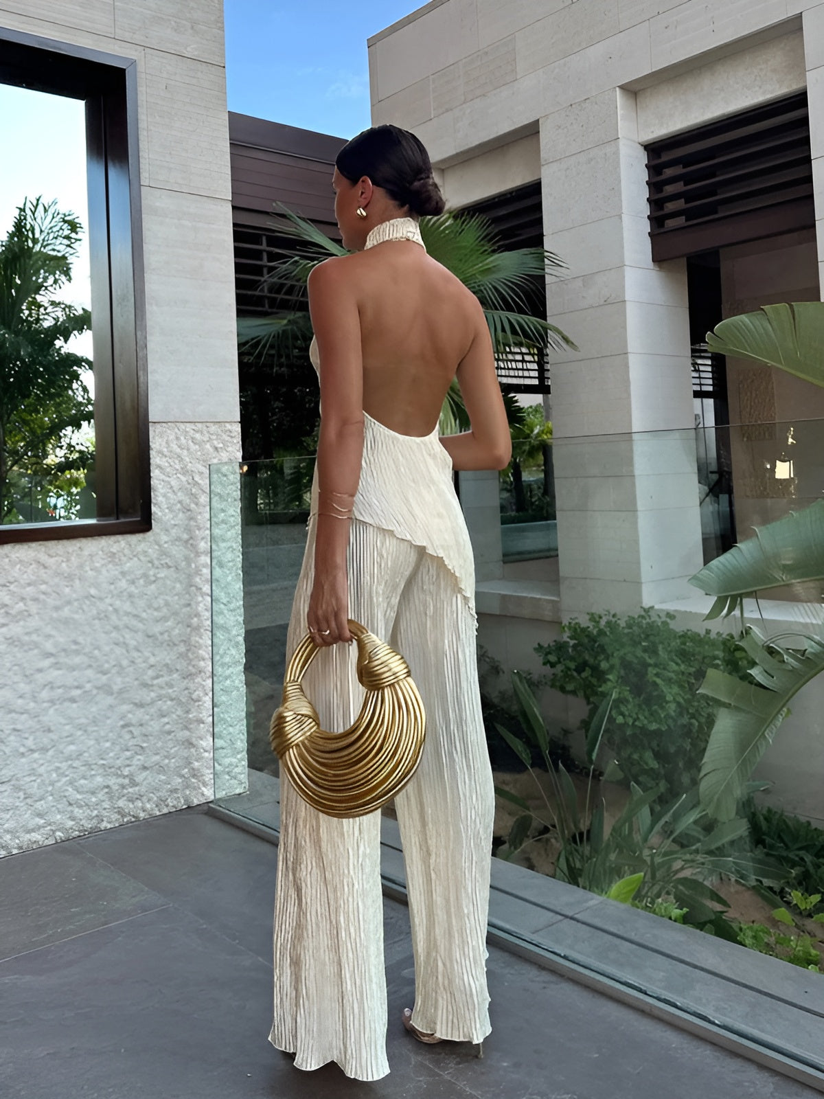 Women's halter neck pleated jumpsuit, back view