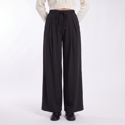 Women's pleated drawstring wide leg trousers in black, front view
