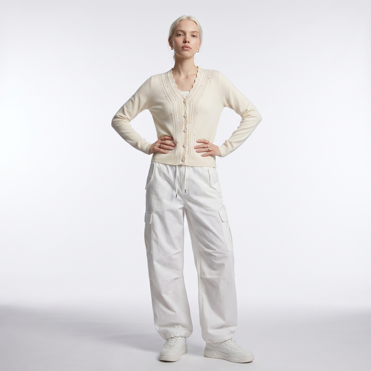 Women's scalloped v-neck pearl cardigan in cream, styled view