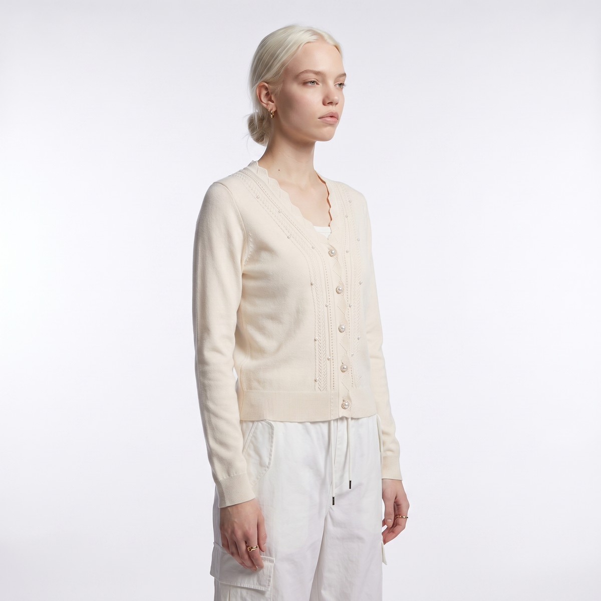 Women's scalloped v-neck pearl cardigan in cream, three-quarter view
